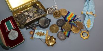 A collection of military medals and cap badges