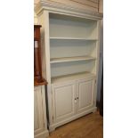 A modern painted open bookcase cupboard W.115cm