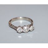 An 18ct white gold three stone diamond ring, size L