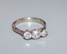 An 18ct white gold three stone diamond ring, size L