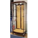 A 1920's mahogany bowfront shop display cabinet H.209cm