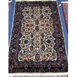 A Persian ivory ground rug 190 x 119cm