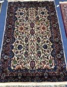 A Persian ivory ground rug 190 x 119cm