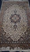 A Kashan style ivory ground rug 218 x 136cm