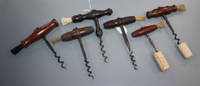 Six 19th century English steel and wood handled corkscrews, five with turned rosewood handles and