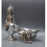 A George V silver baluster caster, London 1919, 4oz., a silver cream boat and a silver fancy link