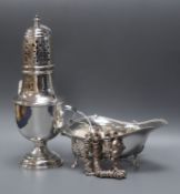 A George V silver baluster caster, London 1919, 4oz., a silver cream boat and a silver fancy link