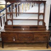 An 18th century oak dresser with open rack W187cm