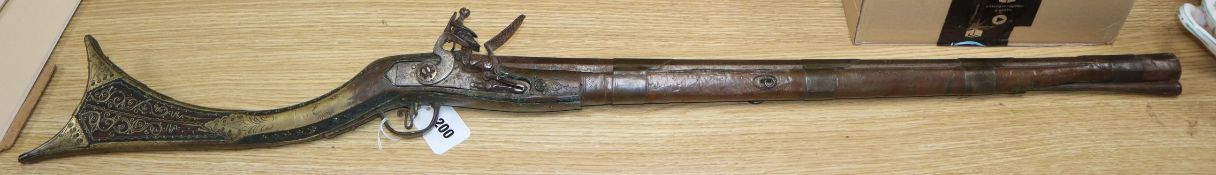 A 19th century Ottoman flintlock musket, with octagonal barrel, the stock with brass wire inlay