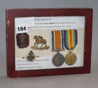 A set of English World War framed medals (pair) and badges