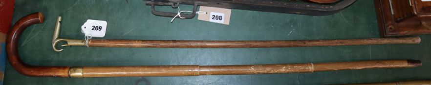 An umbrella cane and a whistle handled cane, stamped 'Orchard'