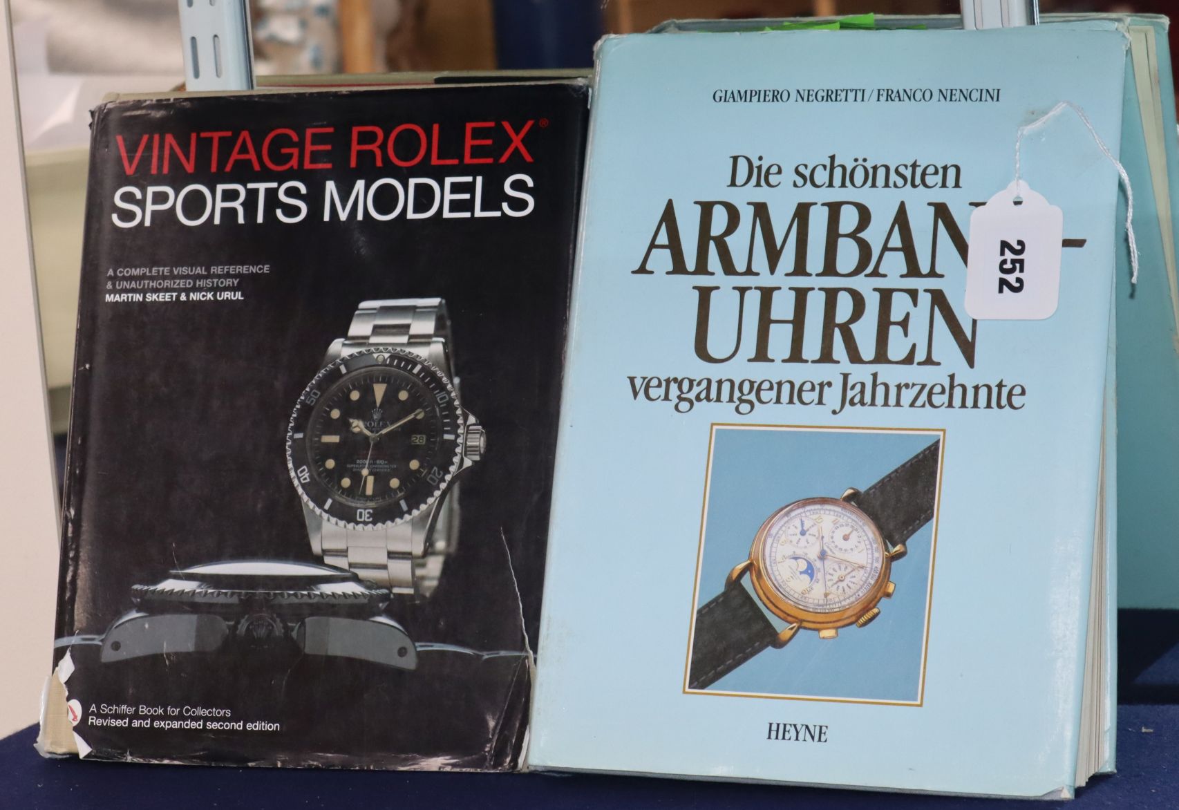 A book Vintage Rolex Watches, a similar book and a group of mostly Rolex watch boxes
