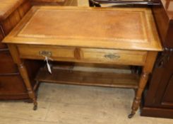 An Edwardian oak writing table W.92cm