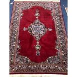 A Persian red ground rug 189 x 126cm