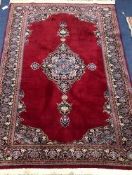 A Persian red ground rug 189 x 126cm