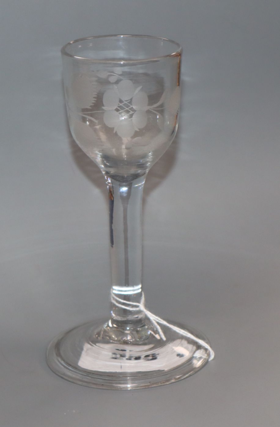 An 18th century cordial glass engraved with a rose and bird, c.1745