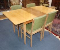 A Gordon Russell walnut dining suite table 152cm extended