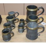 Nine brass rimmed pewter measures, Victorian/Edwardian