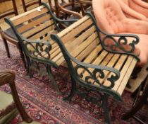 A pair of cast iron and teak slatted garden chairs
