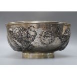 A late 19th/early 20th century Chinese Export white metal bowl, embossed with two dragons chasing