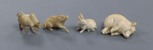 Four European ivory models of a sleeping piglet, a hare, an ox and a wild boar, early 20th century