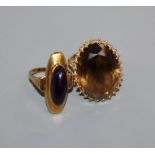 A smoky quartz and 9ct gold dress ring with fancy setting and a yellow metal ring with oval cabochon