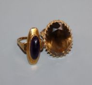 A smoky quartz and 9ct gold dress ring with fancy setting and a yellow metal ring with oval cabochon