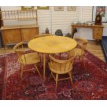 A 1950's satin sycamore or birch suite, purchased at Heals, table, four chairs, sideboard and an