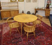 A 1950's satin sycamore or birch suite, purchased at Heals, table, four chairs, sideboard and an