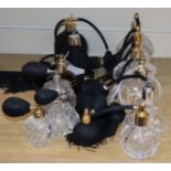 Five black glass and ceramic perfume atomisers and nine cut glass examples with black bulbs and