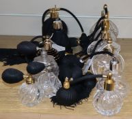 Five black glass and ceramic perfume atomisers and nine cut glass examples with black bulbs and