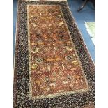 An Indian red and blue ground carpet 319 x 153cm