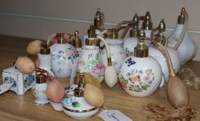 Sixteen ceramic perfume atomisers, mostly decorated with flowers