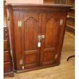 A George III oak corner cupboard W.93cm