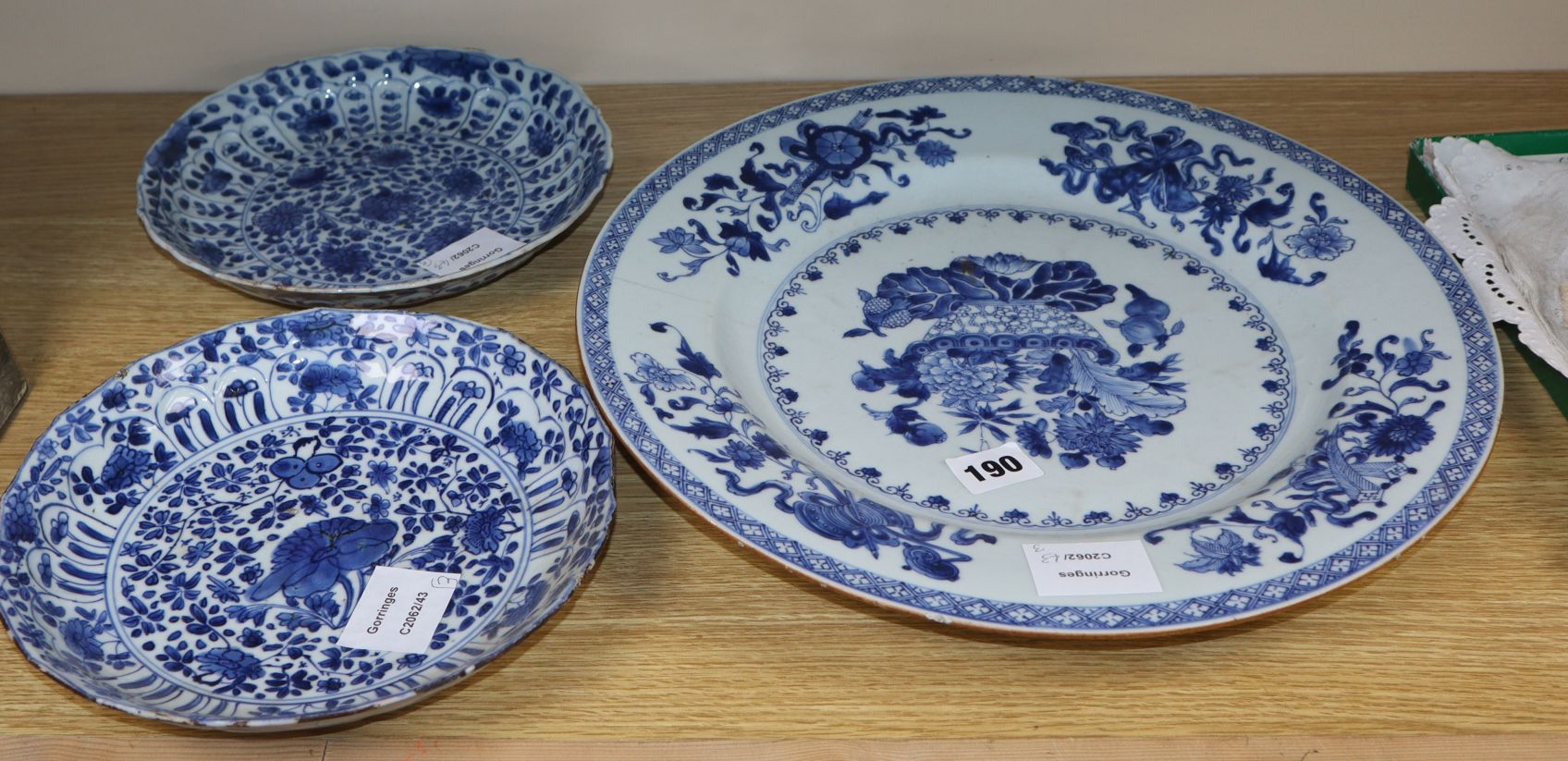 A pair of Chinese Kangxi blue and white floral dishes and a Qianlong blue and white dish, diameter