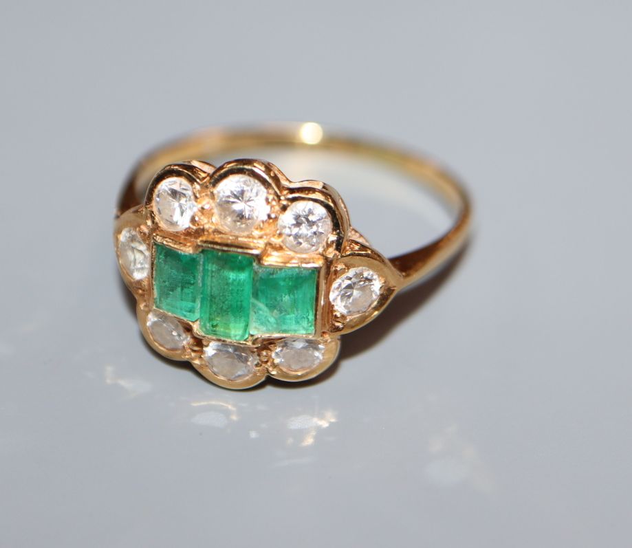 A gold, diamond and three stone emerald cluster ring, size Q.