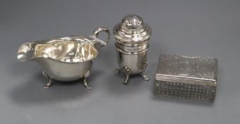 A silver sauceboat, a silver sugar sifter and a silver mounted glass toilet jar.