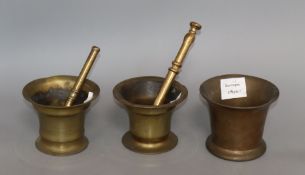 An 18th century brass mortar, 4.5in. and pestle, and two other brass mortars