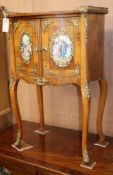 A Louis XV style ormolu-mounted kingwood small commode, enclosed by a pair of doors with porcelain