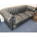 A faded black leather three seater Chesterfield settee W.206cm