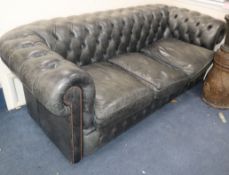A faded black leather three seater Chesterfield settee W.206cm