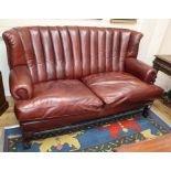 A Victorian design burgundy leather two seater settee W.170cm