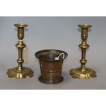 An 18th century bronze mortar and a pair of 18th century brass candlesticks