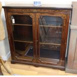 A Sheraton Revival inlaid mahogany bookcase fitted a pair of glazed doors W.106cm