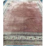 A Ferraghan carpet with multiple lines of guls on a wine ground 330 x 420cm