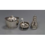 A George III silver mustard pot (a.f.) and spoon, a Victorian silver pepperette and a silver salt