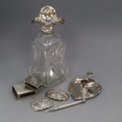 A silver mounted decanter, two silver matchbox holders, chamberstick and three other items.