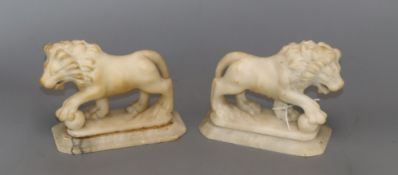 A pair of alabaster lions height 12cm