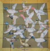 Two Hermes silk scarves, 'Soleil de Soie' (pink border) and 'Sauvagine en Vol' (yellow border) the