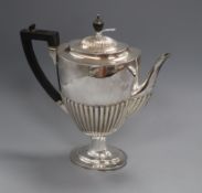 A Victorian demi fluted silver pedestal coffee pot by Edward Hutton, London, 1884, height 28.5cm,